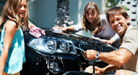 Family Cleaning a Sports Car