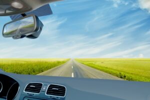 Vehicle on Open Road in Field