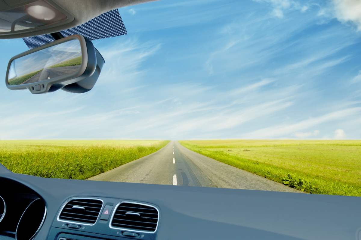 Vehicle on Open Road in Field