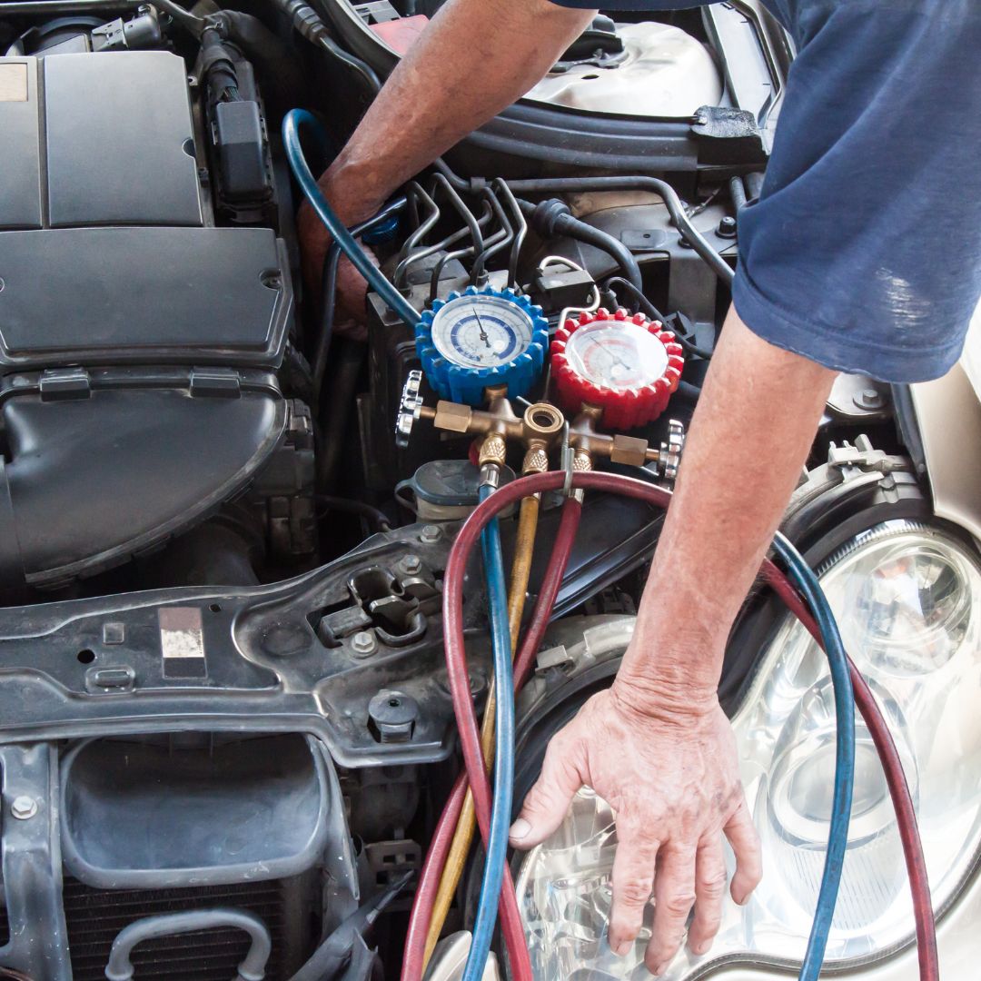 Man using tool to inspect auto