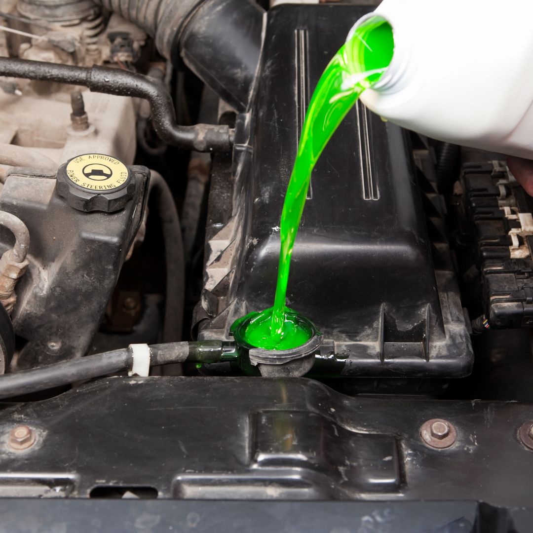 pouring coolant into a radiator